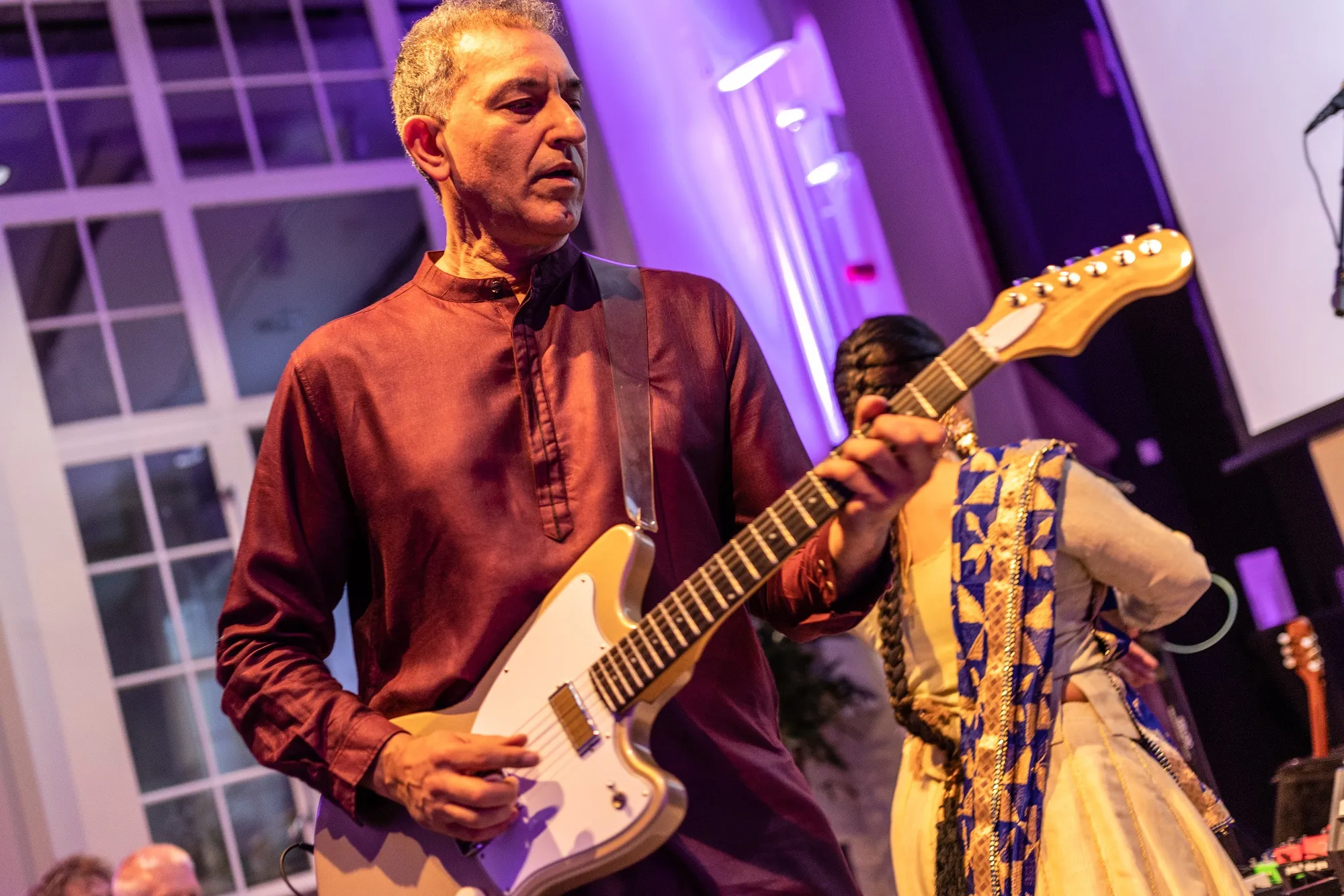 Portrait of Aziz Ibrahim with his guitar